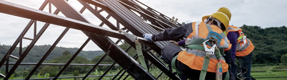 Trade workers building a roof