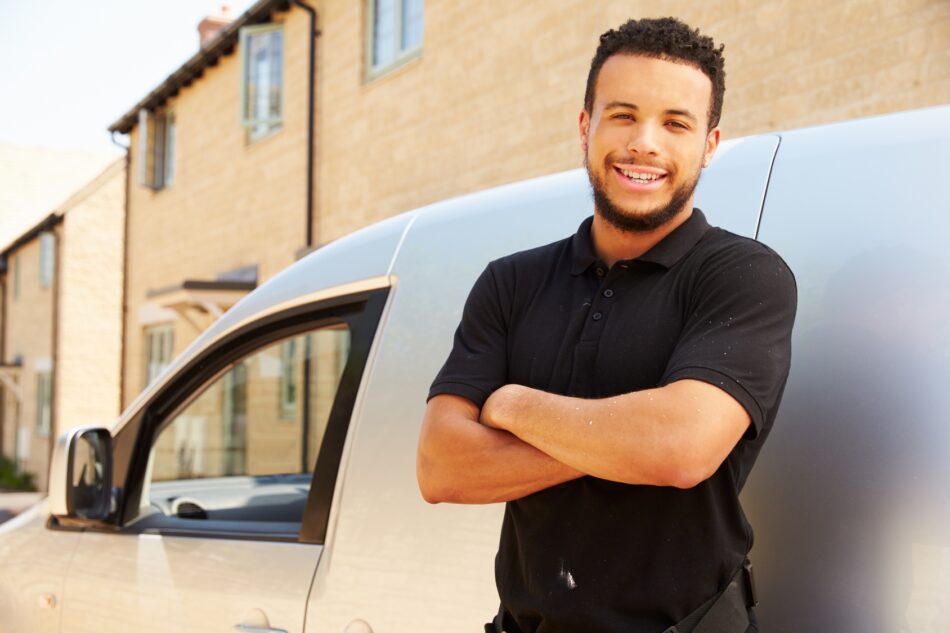 Man smiling in front of work vehicle