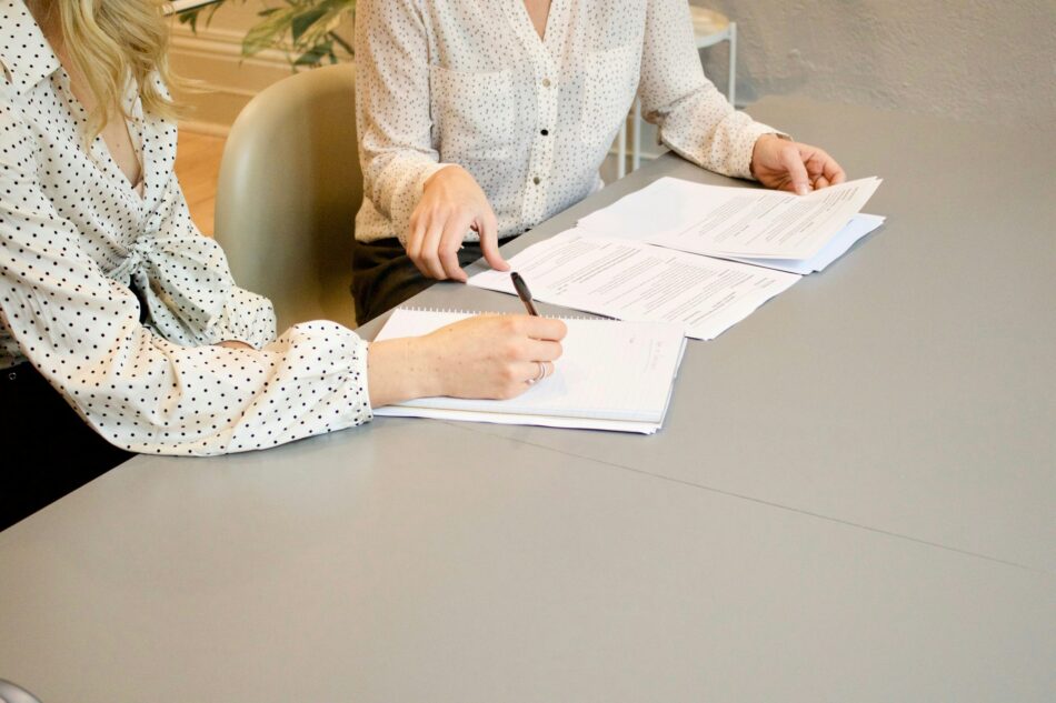 Hands looking at policy documents