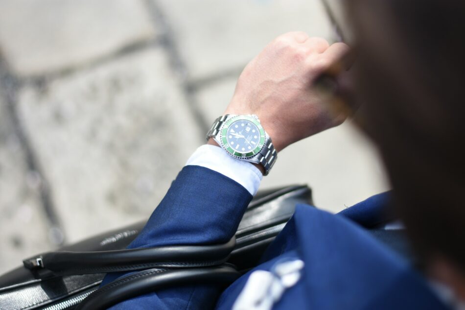 Business man looking down at watch
