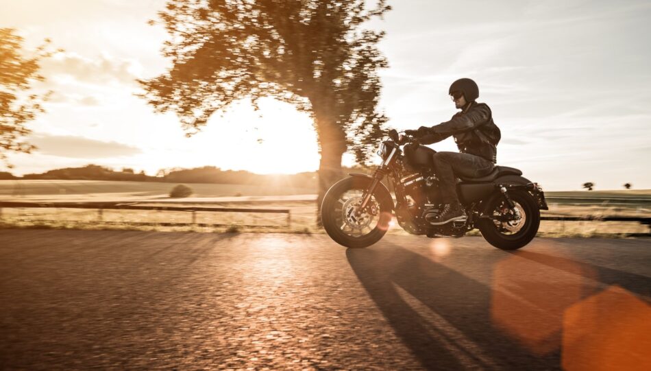 Man on motorcycle at sunset