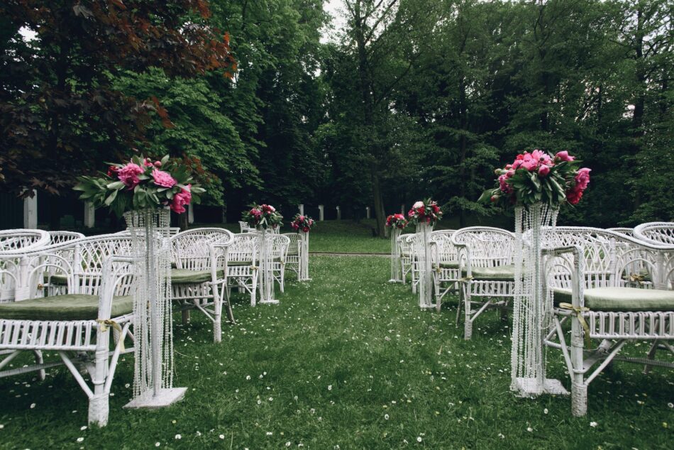 View down the aisle of a lush green backyard garden wedding