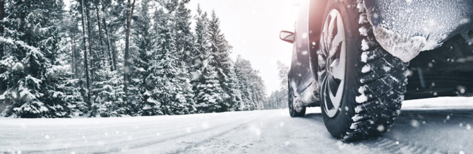 Closeup of tire driving on snowy road