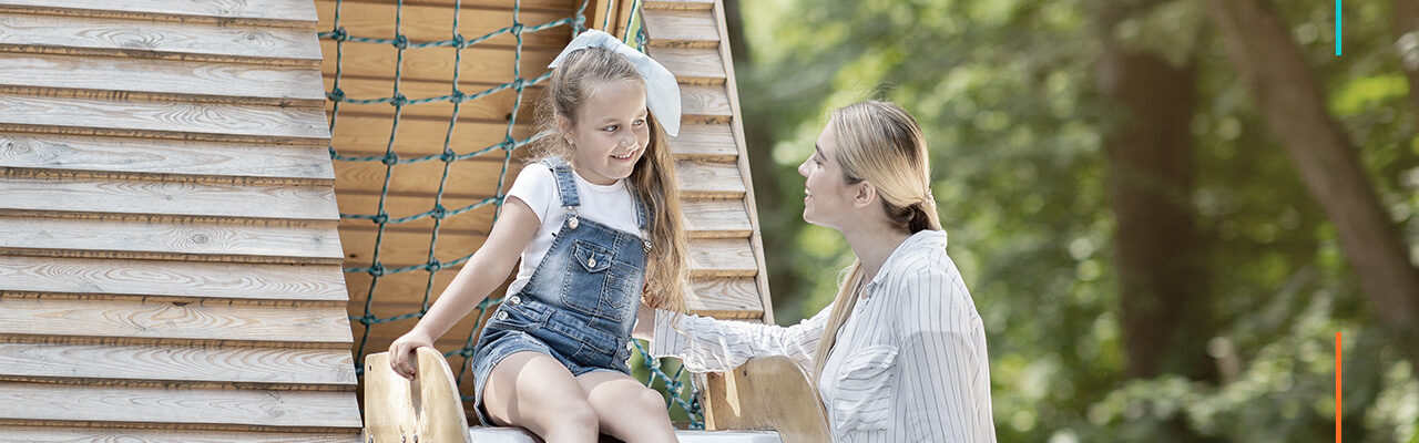 Woman with young girl at park
