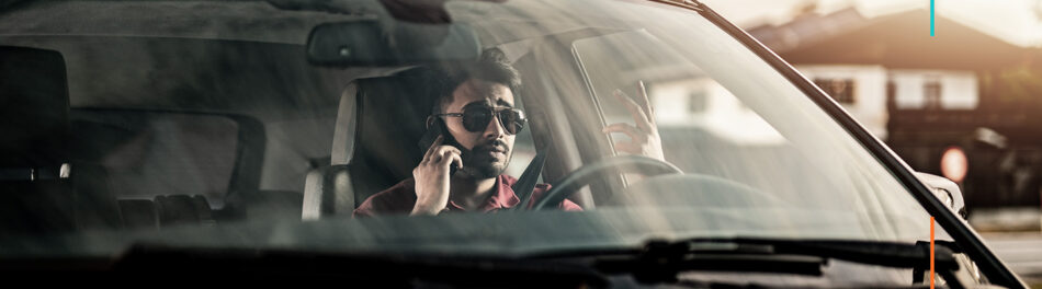 Man talking on phone in car