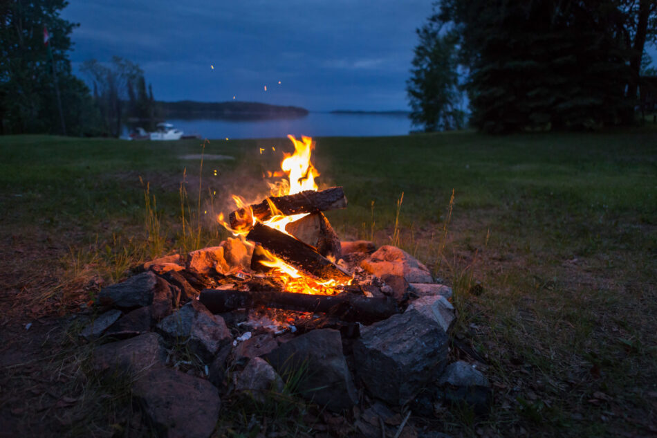 Campfire on lakeside camp spot