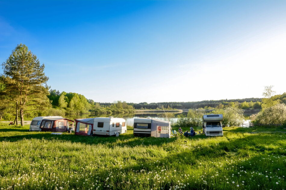 Caravans and camping on the lake. Family vacation outdoors, travel concept
