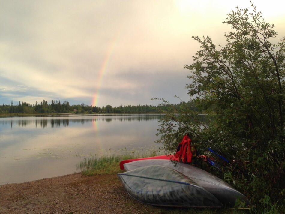 crimson lake provincial park in rocky mountain house near edmonton, with canoes on the shore of a lake