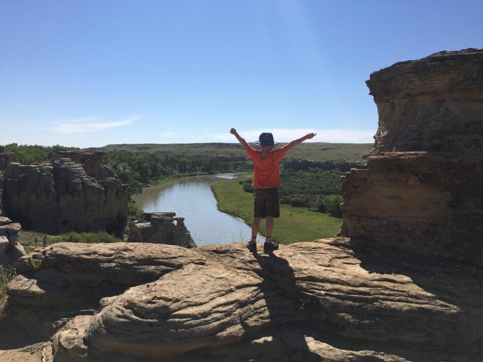 Woman hiking and overlooking Dinosaur Provincial Park