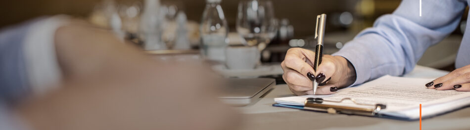 A woman writes in the office, highlighting the considerations around a return to the office and the impact on insurance rates.