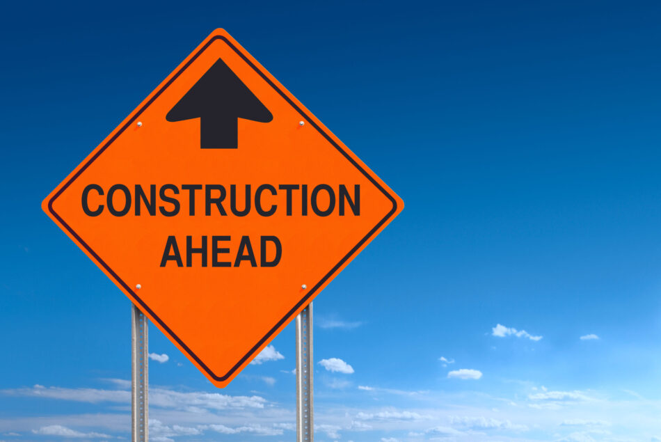 Conceptual road sign warning of construction ahead - a clipping path is included to separate sign from bkg.