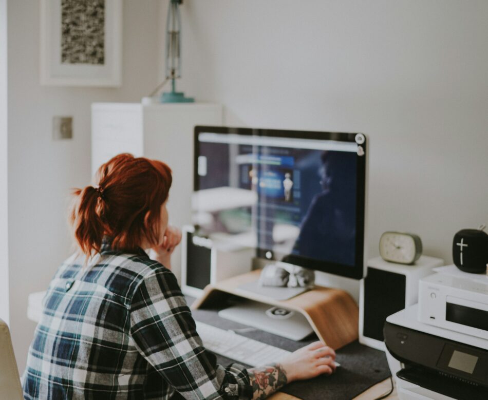 Employee looking at computer at home office