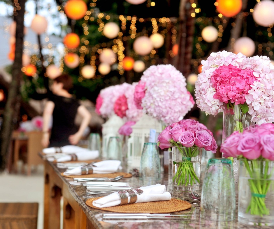 Pink flowers in vases on table at a modern wedding reception