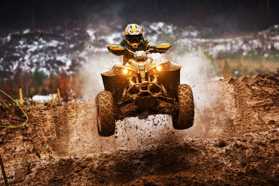 Person riding ATV with helmet
