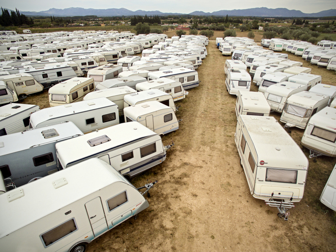 Trailers not in use during the summer, parked in a trailer storage lot.