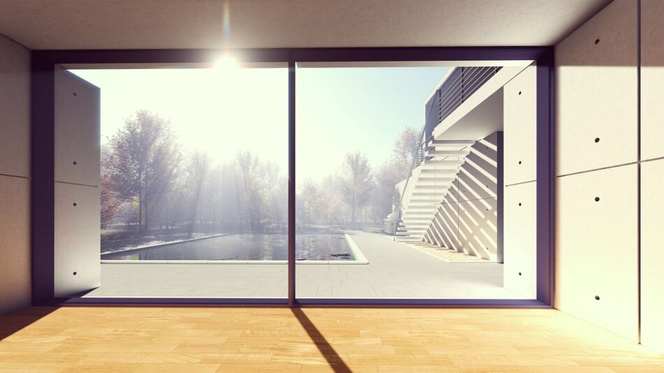 Sun room with large glass window spanning the entire wall with the sun shining in
