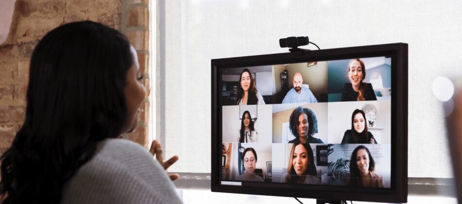 Employee on video call for virtual meeting with team