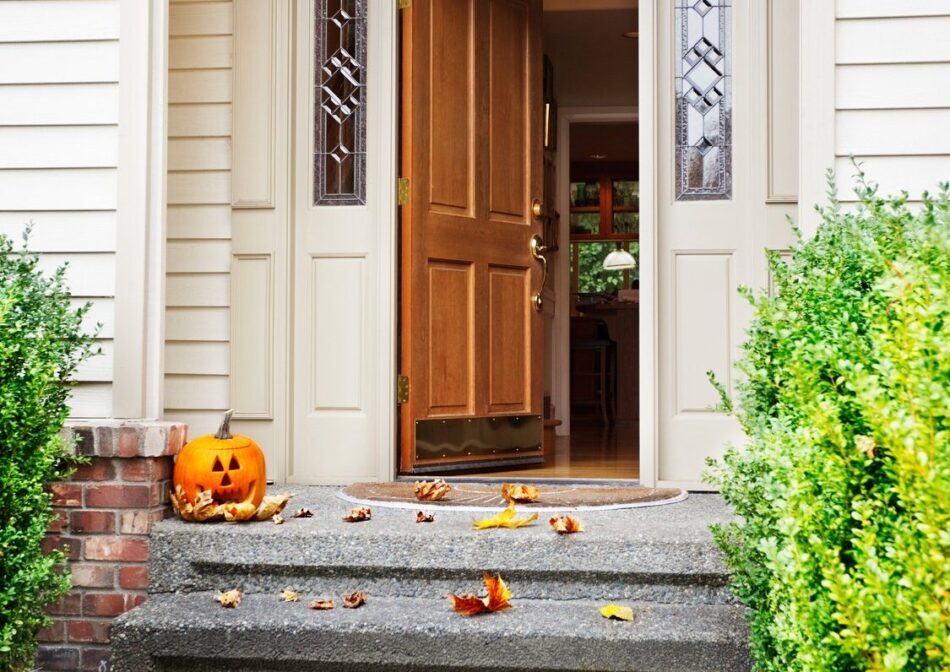 Front of house with front door ajar
