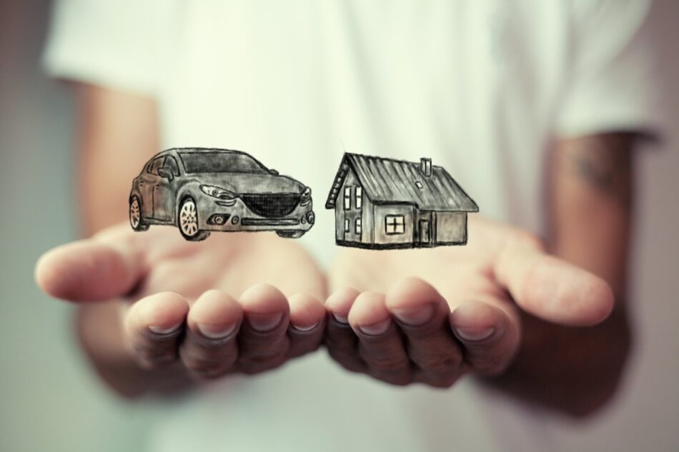 Closeup of two hands palms-up, one with a car icon on top and one with a house icon