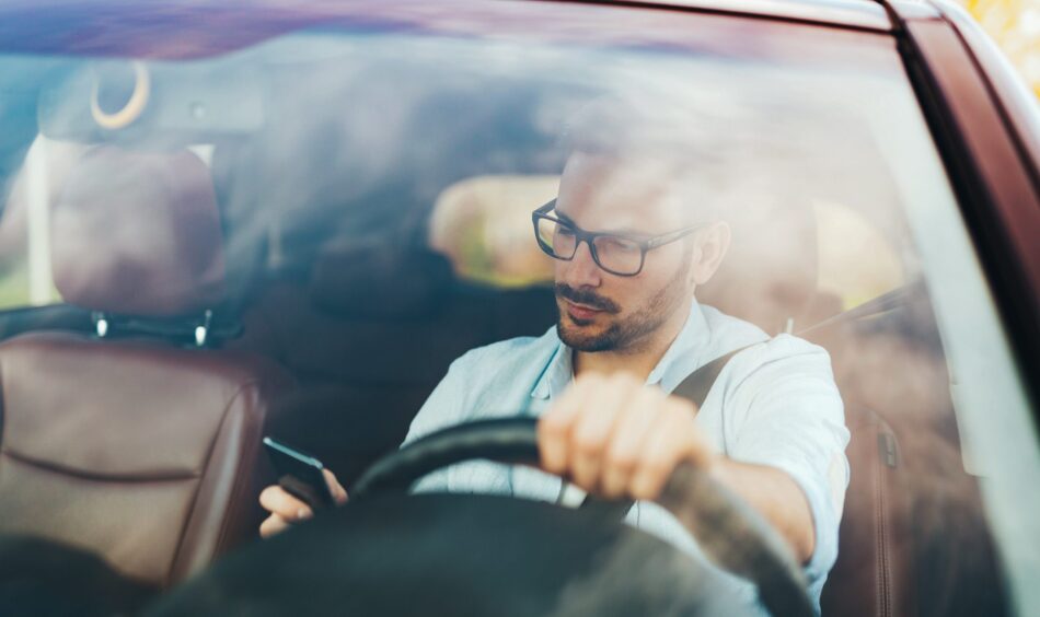 A distracted driver on his phone