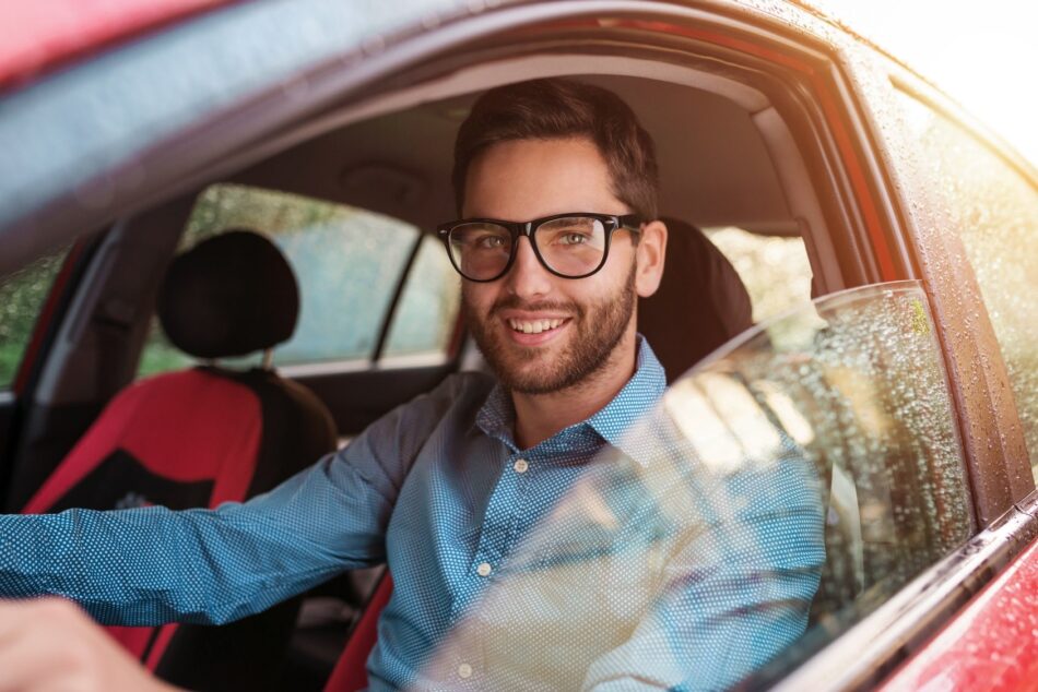 Man in car smiling out the window