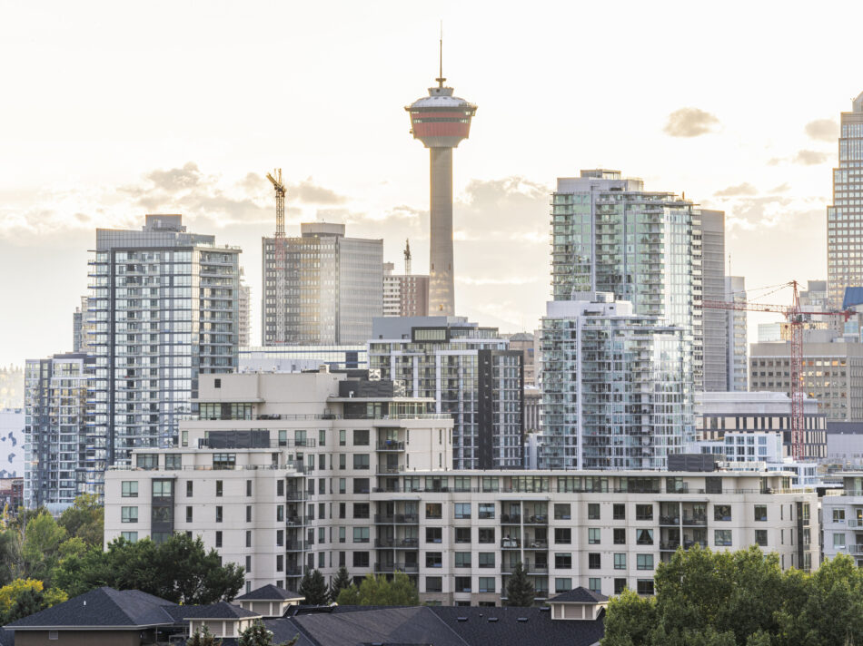 The Calgary Tower with residential buildings against sky