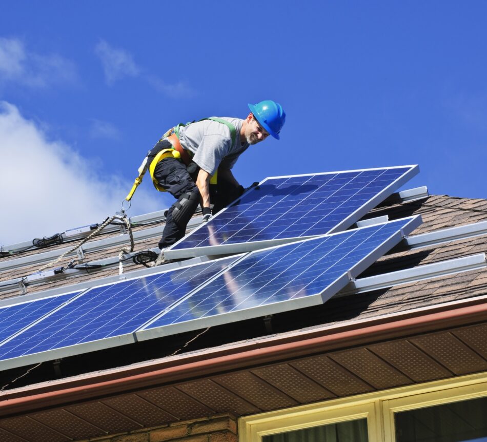 Solar panels being installed by a worker