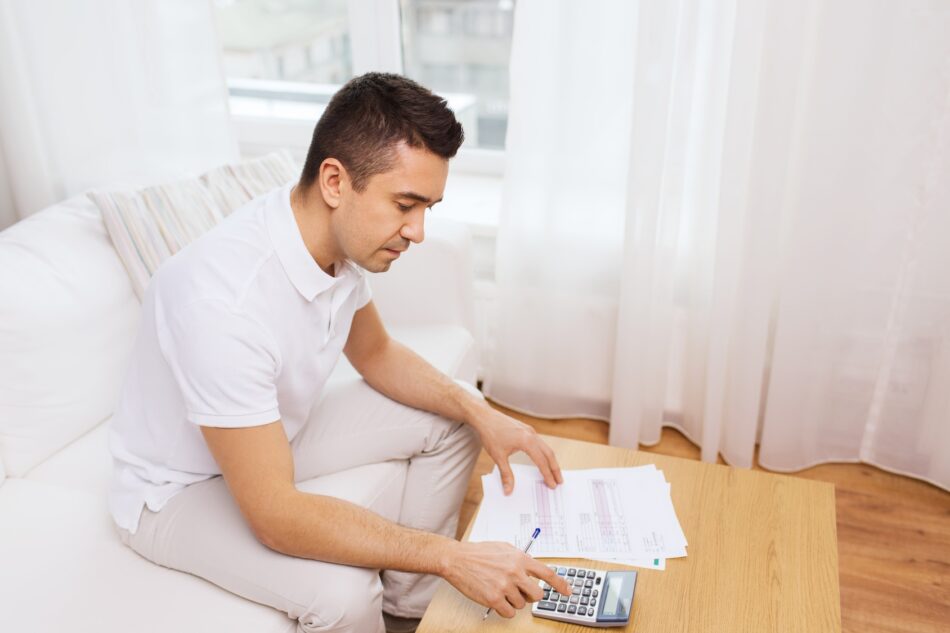 Man looking at papers while sitting in living room