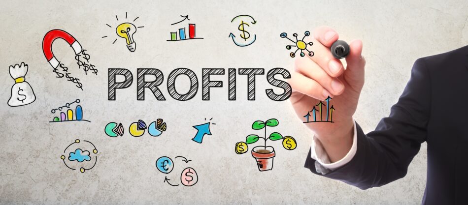 View of hand writing "Profits" on a transparent board