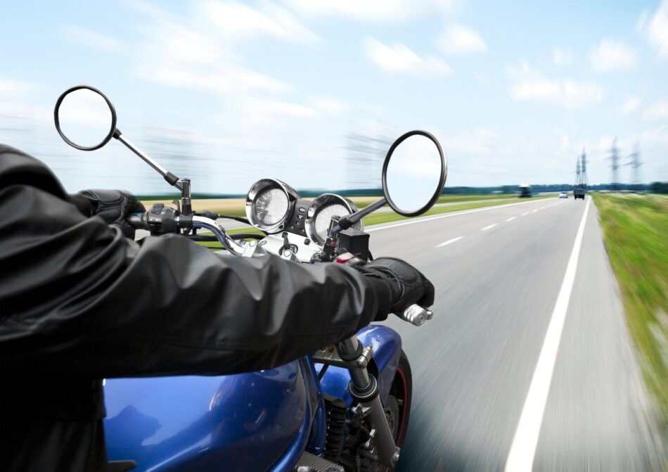 POV view of person riding a motorcycle on a highway in Alberta