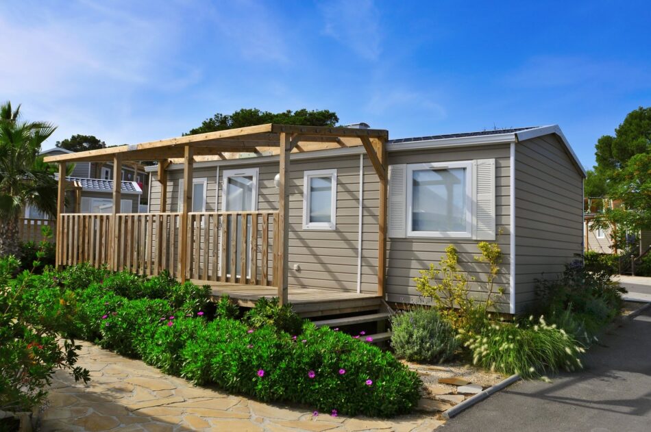 Manufactured home exterior with lush landscaping