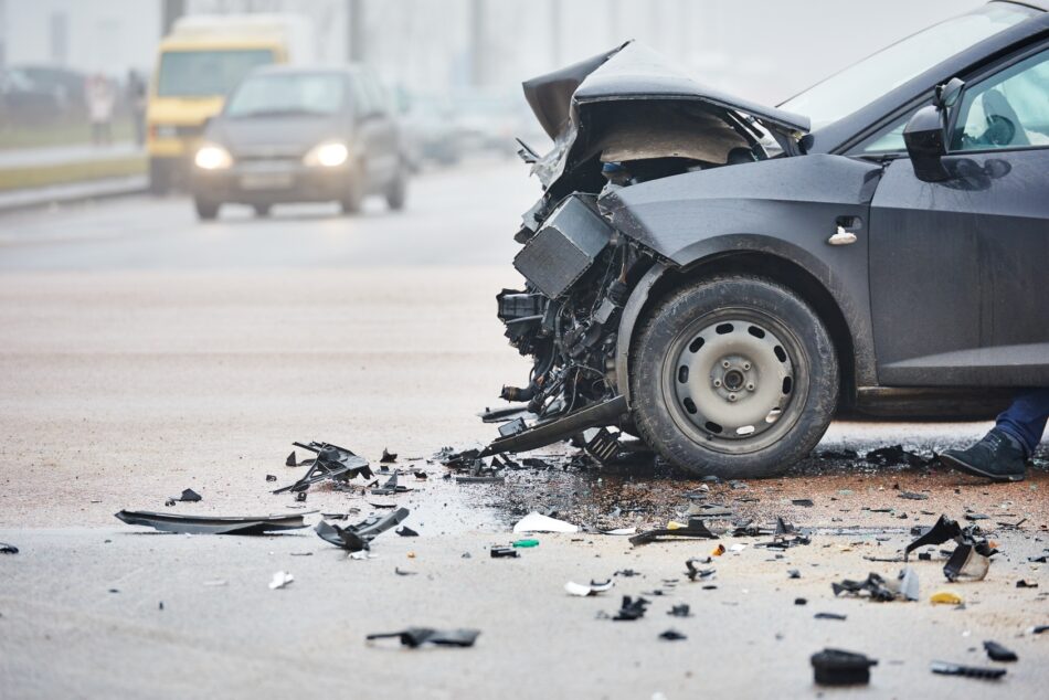a wrecked black car after a car accident