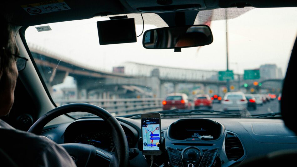 View from backseat of a ride share car with navigation on the dash