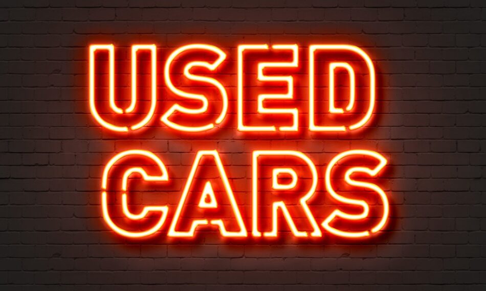 Neon sign that reads "Used Cars"