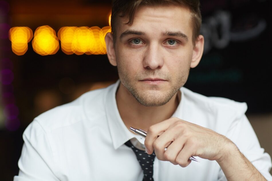 Closeup of young professional man looking at camera