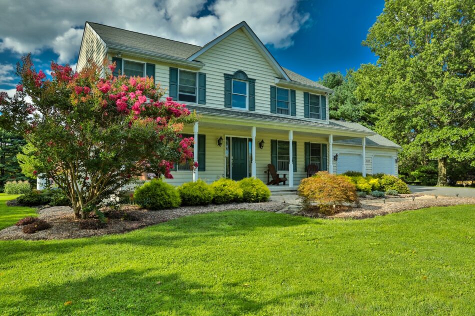 Front view of a heritage home with lush landscaping