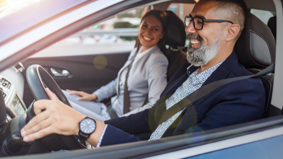 Two friends in car smiling