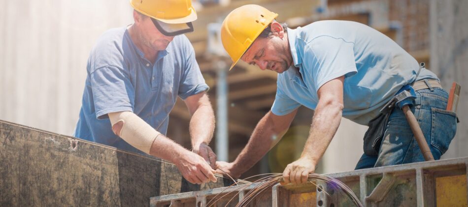 Two contractors working at a construction site