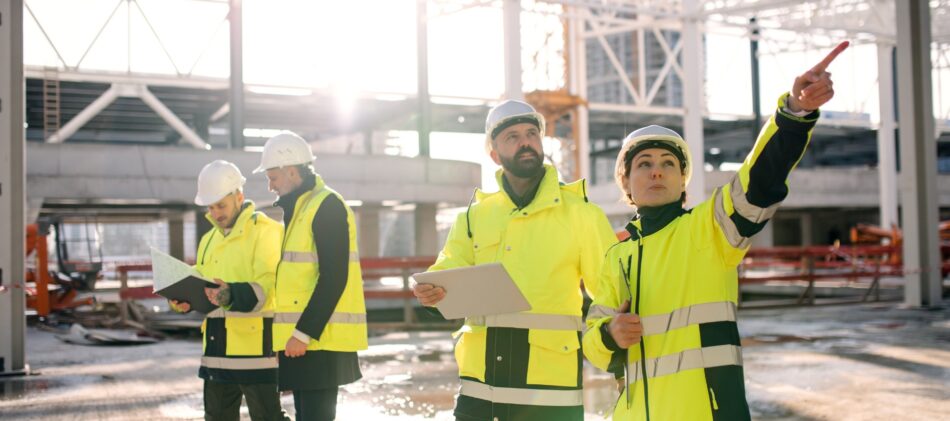 A group of construction workers on site looking around