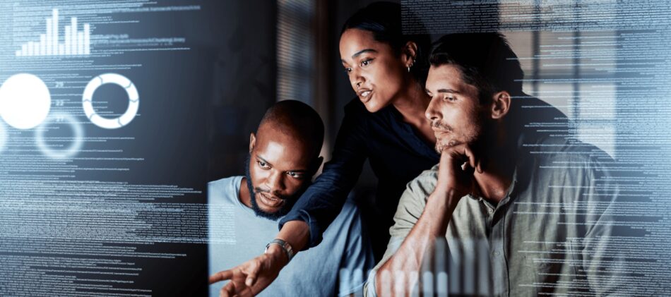 Group of IT workers looking at computer with cyber graphics overlaid on top