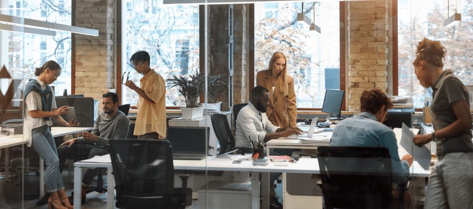 Employees in an office discussing their employee Benefits
