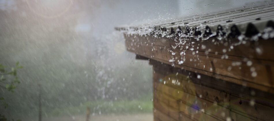 Closeup of rain falling off roof