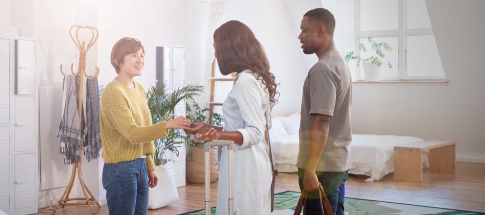 Couple getting keys to apartment from a landlord