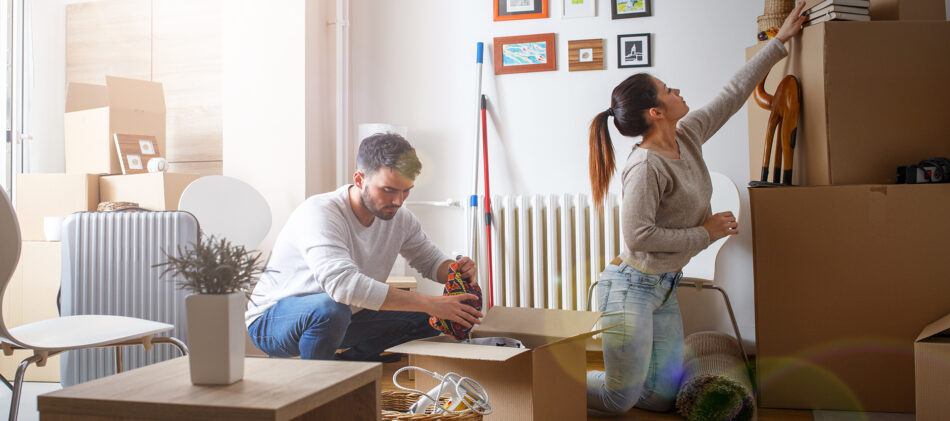 A young couple unpacking in their newly rented home