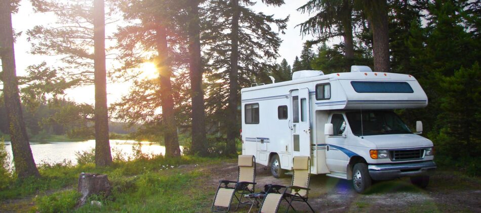 RV parked at a camp site at dusk