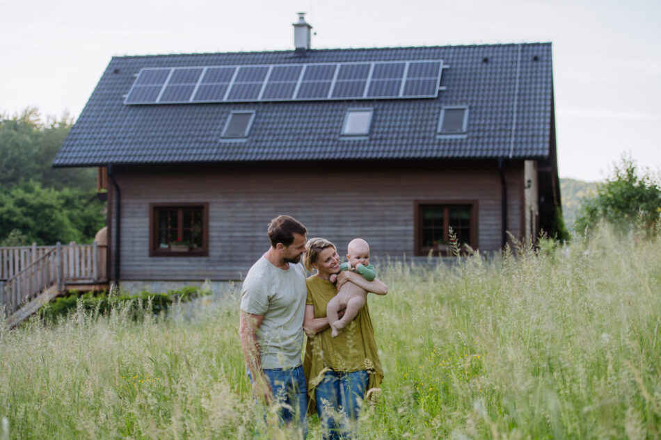 Family in front of home with roof solar panels