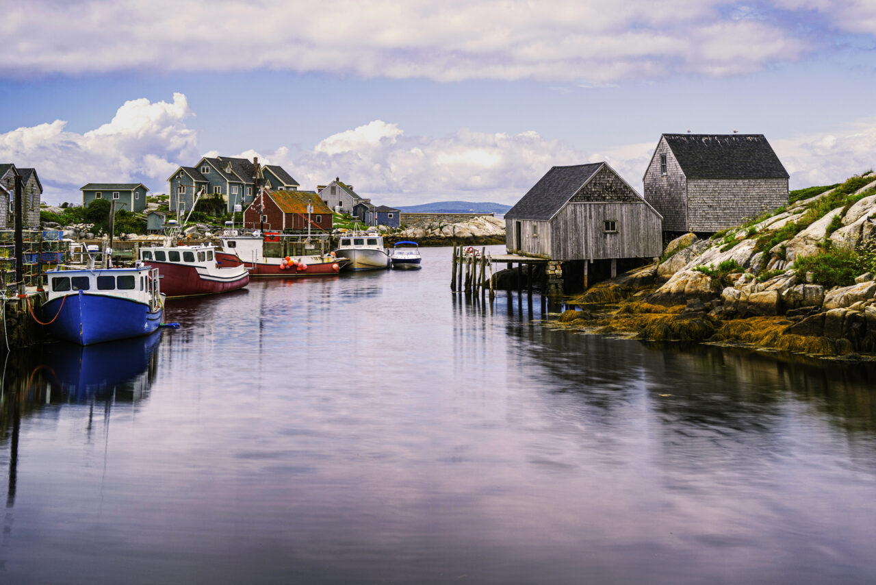 Peggy's Cove Seascape with moored boats and weathered seaside shacks in Nova Scotia, Canada