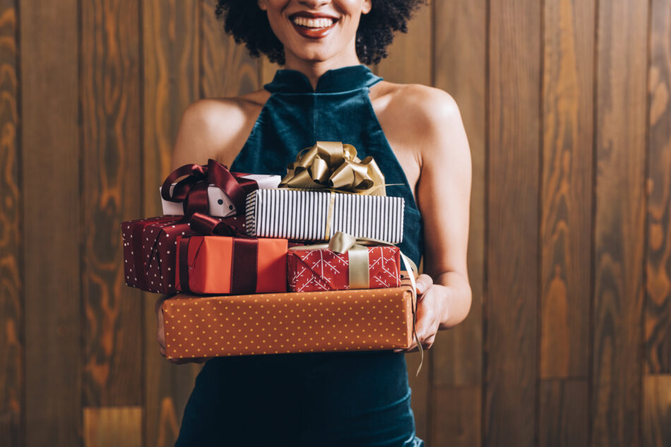 Woman holding stack of presents