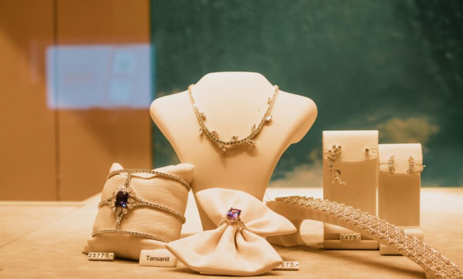 Collection of gold jewelry on stands on display